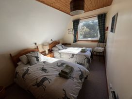 A bedroom with two beds and a window at Suil Na Mara Aultbea