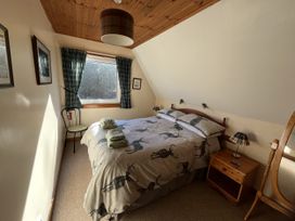 A bedroom with a bed and a window at Suil Na Mara Aultbea