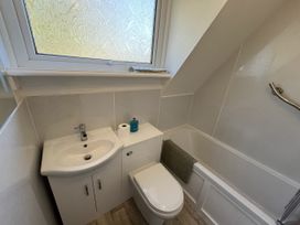 A bathroom with a toilet, sink, and bathtub at Suil Na Mara Aultbea