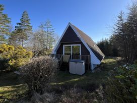 A house with deck and storage shed in the garden at Suil Na Mara Aultbea