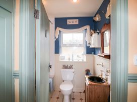 A bathroom with a toilet and sink at Herons Cove Cottage Ballydehop