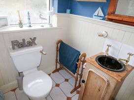 A bathroom with a toilet and a sink at Herons Cove Cottage Ballydehop