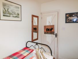 A bedroom with a bed and decor at Herons Cove Cottage in Ballydehop