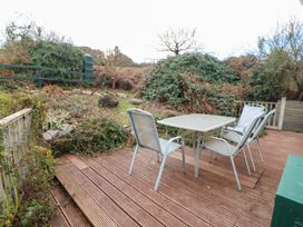 A garden with a table and chairs at Herons Cove Cottage Ballydehop