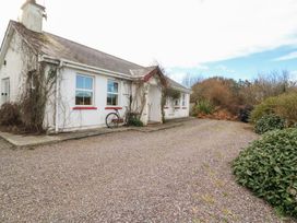 A house with a bicycle in front at Herons Cove Cottage Ballydehop
