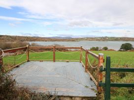 A deck area overlooking water at Herons Cove Cottage Ballydehop