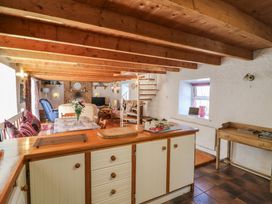 A kitchen with an open layout and dining area at Fuschia Cottage in Waterville, County Kerry