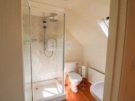 A bathroom with a shower and toilet at Fuschia Cottage in Waterville, County Kerry