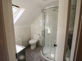A bathroom with a shower and toilet at Fuschia Cottage Waterville, County Kerry
