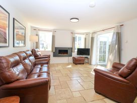 A living room with a sofa and a television at Mill Lodge in Brisley