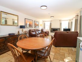 A living room with a dining table and sofa at Mill Lodge in Brisley