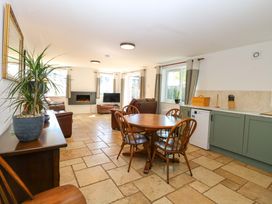 A dining room with a table and chairs at Mill Lodge in Brisley