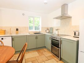 A kitchen with appliances and a table at Mill Lodge in Brisley