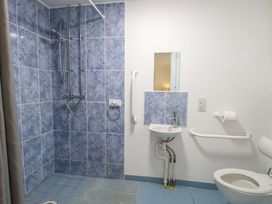 A bathroom with a shower, sink, and toilet at Mill Lodge in Brisley