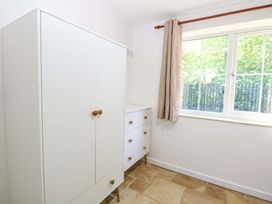 A bedroom with a wardrobe and a chest of drawers at Mill Lodge in Brisley