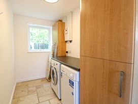 A laundry room with a washing machine and countertop at Mill Lodge in Brisley