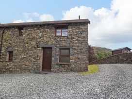An outdoor view of a stone cottage at Copper Beech Cottage in Torver