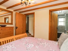 A bedroom with a bed and dresser at Copper Beech Cottage Torver