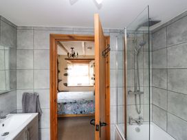 A bathroom with a shower and bathtub at Copper Beech Cottage in Torver