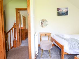 A bedroom with a bed and bedside table at Stabal Cottage in Dolgellau
