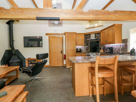 A kitchen with wooden furniture and appliances at Yew Tree Cottage in Torver