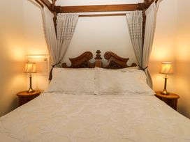 A bedroom with a bed and lamps at Yew Tree Cottage in Torver