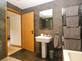 A bathroom with a sink and towels at Yew Tree Cottage in Torver