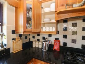 A kitchen with a cabinet and counter space at Stone Cottage in Waterville, County Kerry