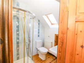 A bathroom with a shower and toilet at Stone Cottage Waterville, County Kerry