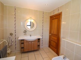 A bathroom with a sink and a mirror at Stone Cottage in Waterville, County Kerry