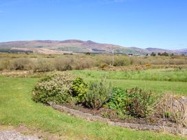 A landscape with shrubs and mountains in the background at Stone Cottage, Waterville, County Kerry