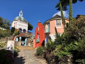 An outdoor view of unique buildings and pathways at Tafarn Trip in Tan Y Bwlch, Maentwrog