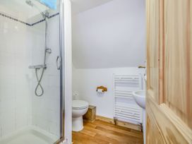 A bathroom with a shower cubicle toilet sink and towel radiator at Glan Nug Bach in Rhydlydan near Betws-y-Coed