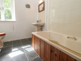 A bathroom with a bathtub and sink at Swallows St Keverne, Lizard Peninsula