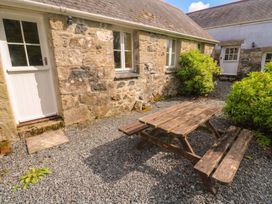 An outdoor area with a picnic table and plants at Swallows, St Keverne, Lizard Peninsula