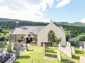 A stone church with a graveyard in a rural hilly area at St.Mary's in Tal y Llyn near Dolgellau