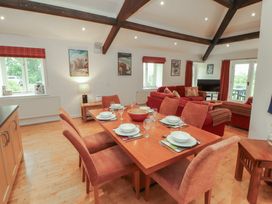 A dining room with a table set for dinner at Winster Fields, Cartmel Fell near Windermere