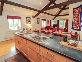A kitchen with a sink and dining area at Winster Fields Cartmel Fell near Windermere