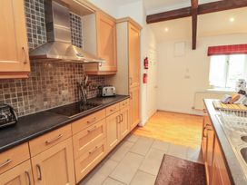 A kitchen with cabinets and appliances at Winster Fields Cartmel Fell near Windermere