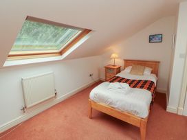A bedroom with a bed and a window at Winster Fields Cartmel Fell near Windermere