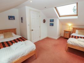 A bedroom with two beds and a skylight at Winster Fields Cartmel Fell near Windermere