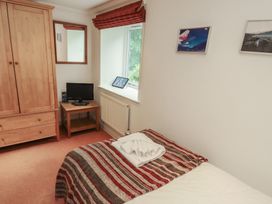 A bedroom with a bed and television at Winster Fields Cartmel Fell near Windermere