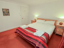 A bedroom with a bed and nightstands at Winster Fields Cartmel Fell near Windermere