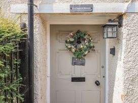 An entryway with a door and wreath at 24 Church Street in Winsham