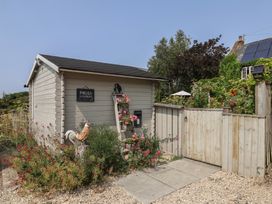 A parcel box and gate with flowers in the garden at Church Farmhouse in Winsham
