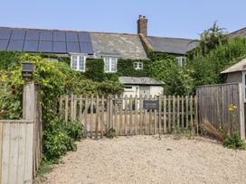 An entrance with a fence and welcome sign at Church Farmhouse in Winsham