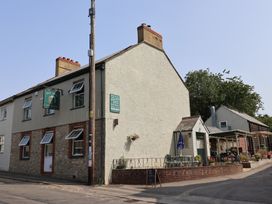 A pub with outdoor seating at The Bell in Winsham