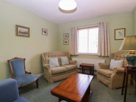 A living room with a sofa and armchairs at The Lock House in Gloucester