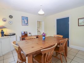 A dining room with a wooden table and chairs at The Lock House in Gloucester