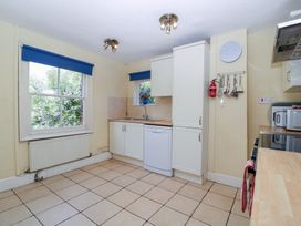 A kitchen with cabinets and appliances at The Lock House in Gloucester